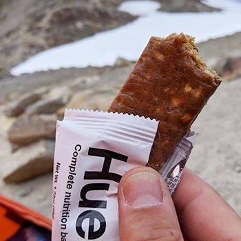 A person holding a Huel bar