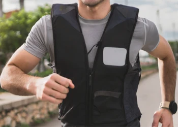 A person running outside with a weighted vest