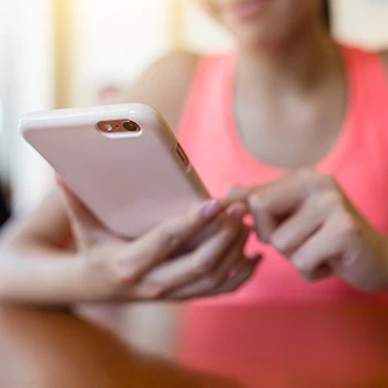 A woman browsing online to buy Huel products