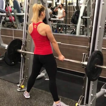 girl in the gym doing romanian deadlifts