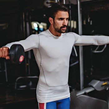 man doing lateral raise with a dumbbell