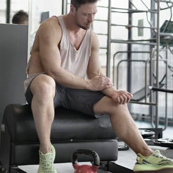 man sitting down in a gym