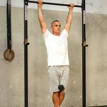 man doing a weighted pull up