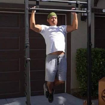man doing a wide grip pull up