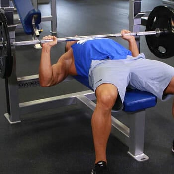 man doing barbell bench press