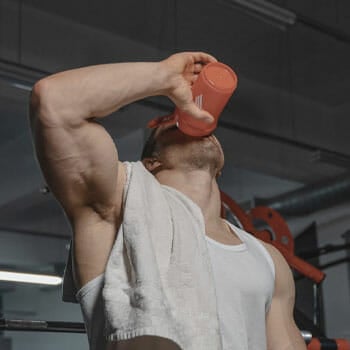 man drinking from a tumbler