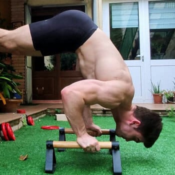 shirtless man in a pike push up position