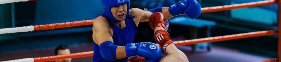 men wearing boxing gears in a boxing match