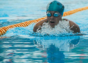 a man swimming in an olympic pool