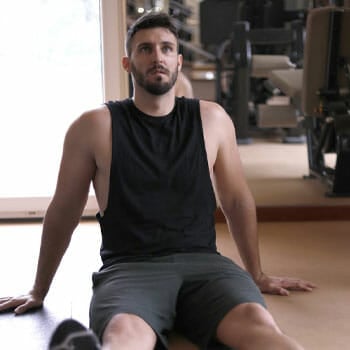 man sitting down in a gym