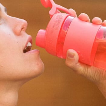 woman drinking from tumbler