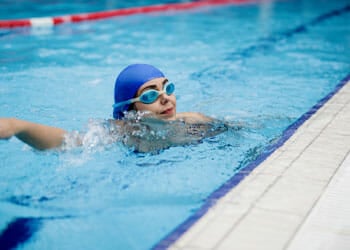 A woman swimming at a pool