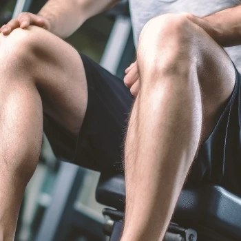 A close up shot on a man's leg doing his workout