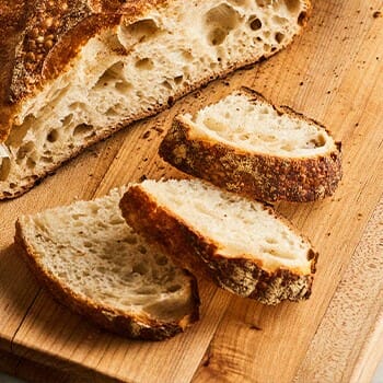 Sliced sourdough bread on top of a chopping board