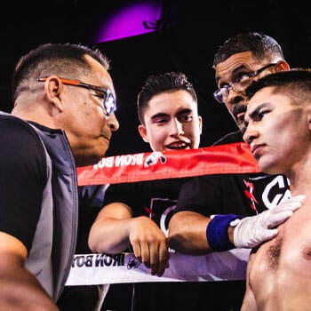 coach talking to his athlete inside the boxing ring