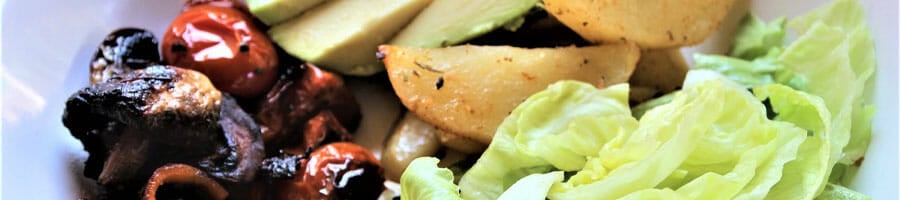 bowl filled with green salad and potatoes