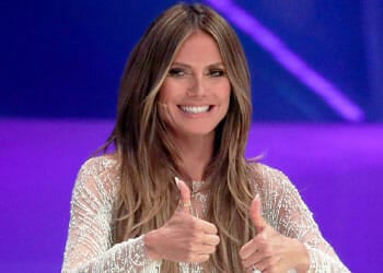 heidi klum raising a two thumbs up while smiling