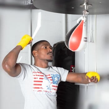 black man punching using a speed bag