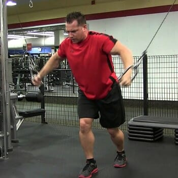 man working out with a cable machine