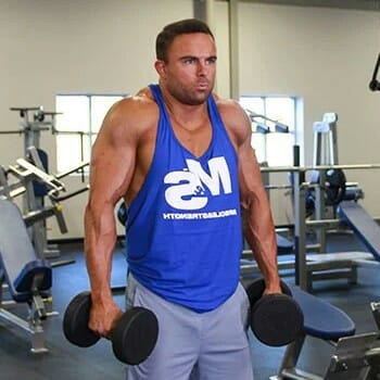 man lifting a barbell in a gym