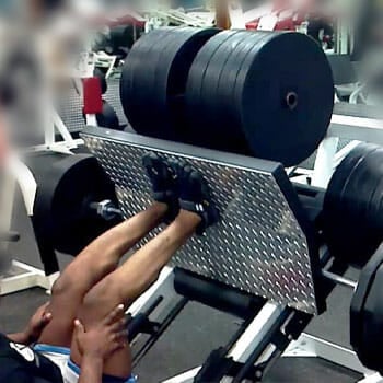 man working out his legs in a gym