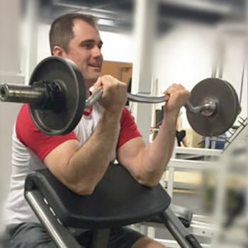 man in a preacher curl position