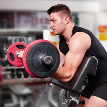 man working out on a bench in gym