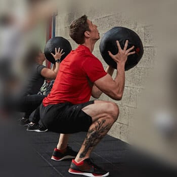 man using a medicine ball to workout