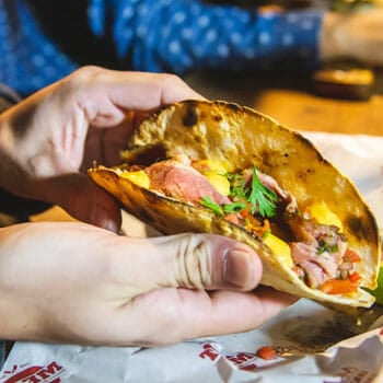 person showing off his tortilla chunks