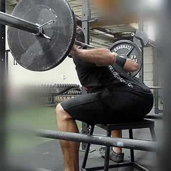 man doing weightlifting while sitting down