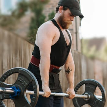 man doing deadlifts outdoors