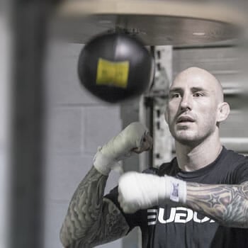 bald man working out with a speed bag