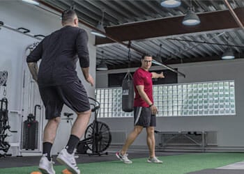 man working out with a trainor