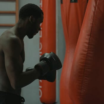 man boxing with a punching bag