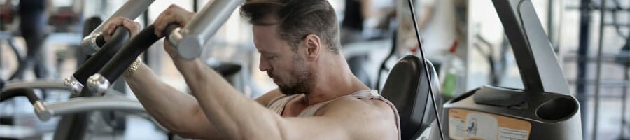 man working out his arms inside a gym