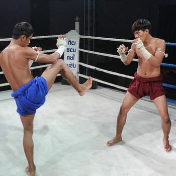 athletes in a middle of a muay thai match