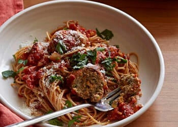 red pasta with meatballs in a plate