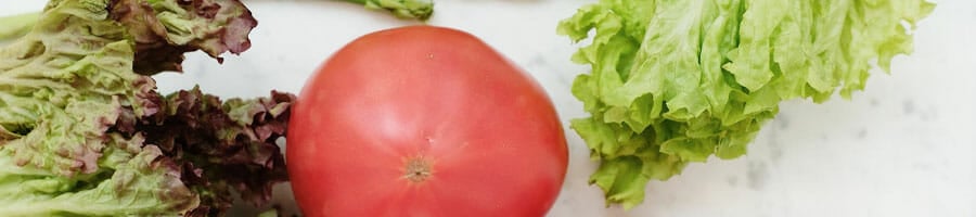 cabbages and tomatoes on marble top