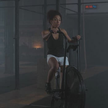 black female working out with a gym bike