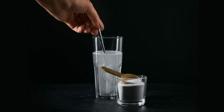 A person making a glass of creatine drink