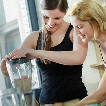 Two girls making a protein shake