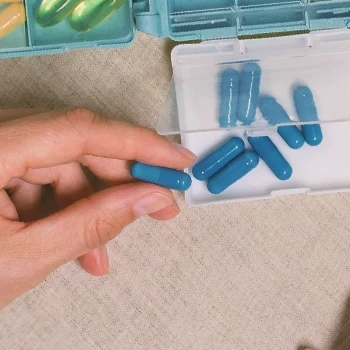 A person holding diet pills