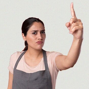 A woman showing index finger warning with a serious face