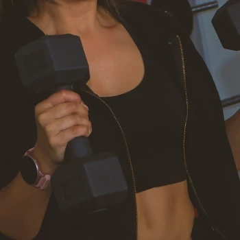 A woman using a dumbbell in her workout