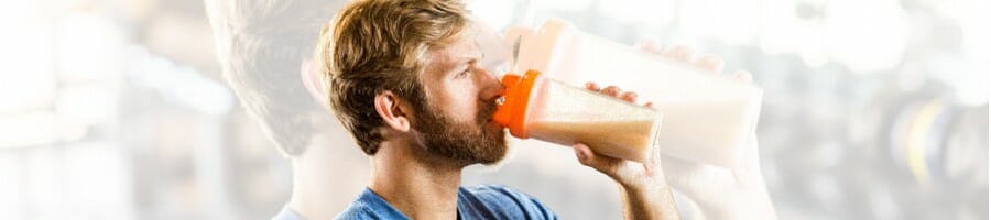 A guy drinking a creatine filled drink