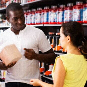 Athletes having a conversation inside a workout supplement store