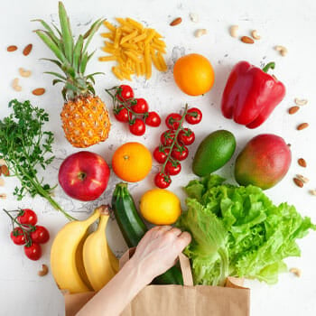 different fruits and vegetables and a bag