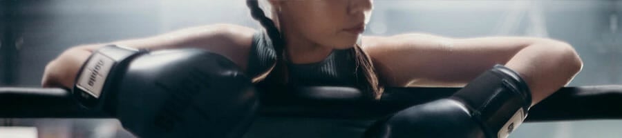 woman wearing a boxing gloves inside a gym