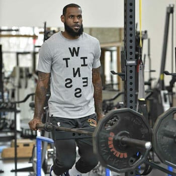 lebron james wearing a shirt and working out in a gym