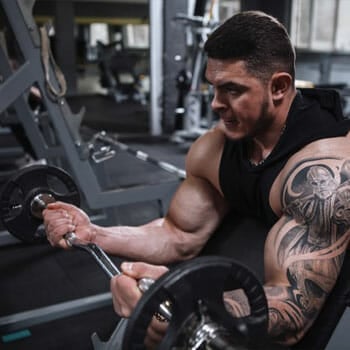 man using a barbell to workout his arms